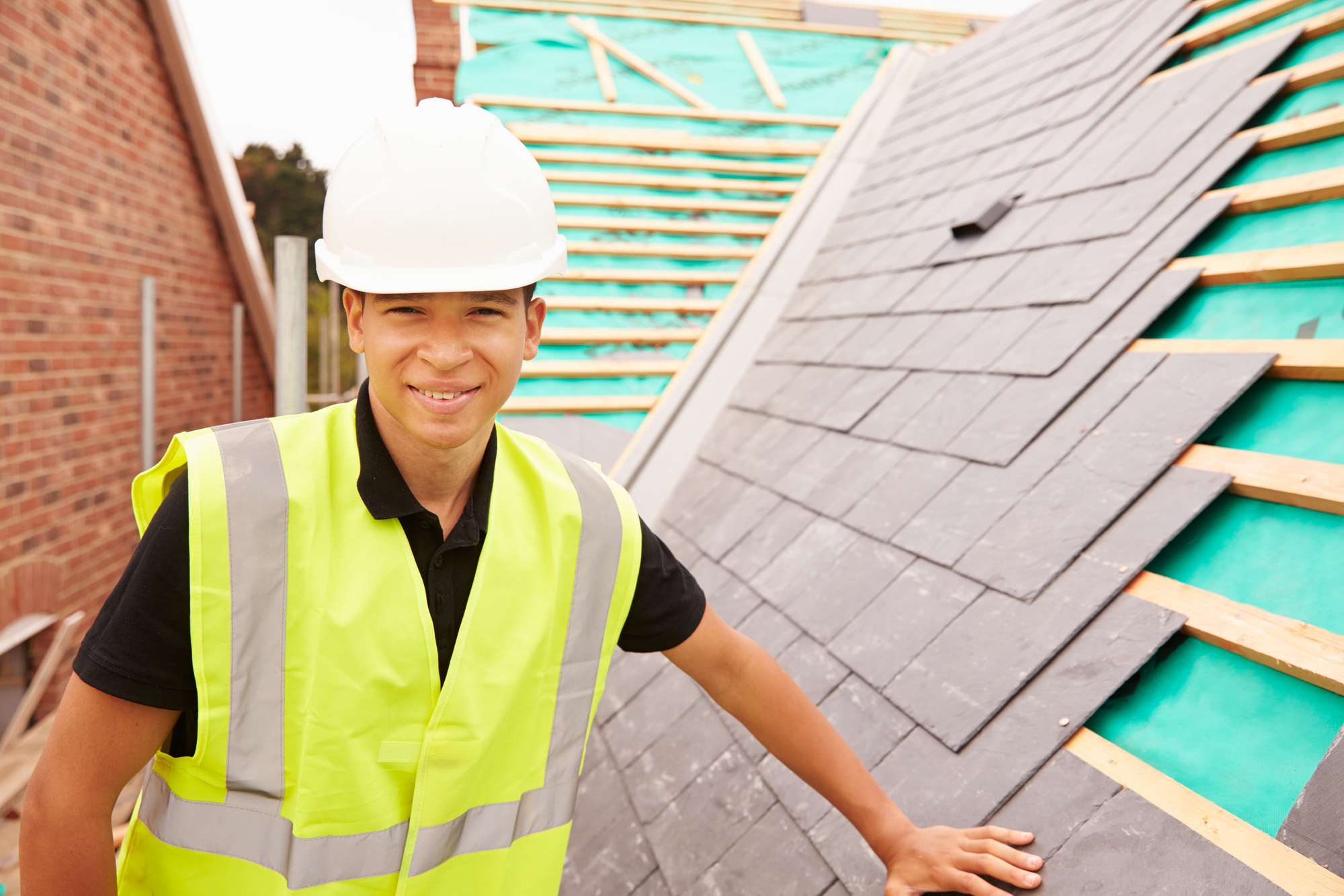 Worker Installing Roof On A House