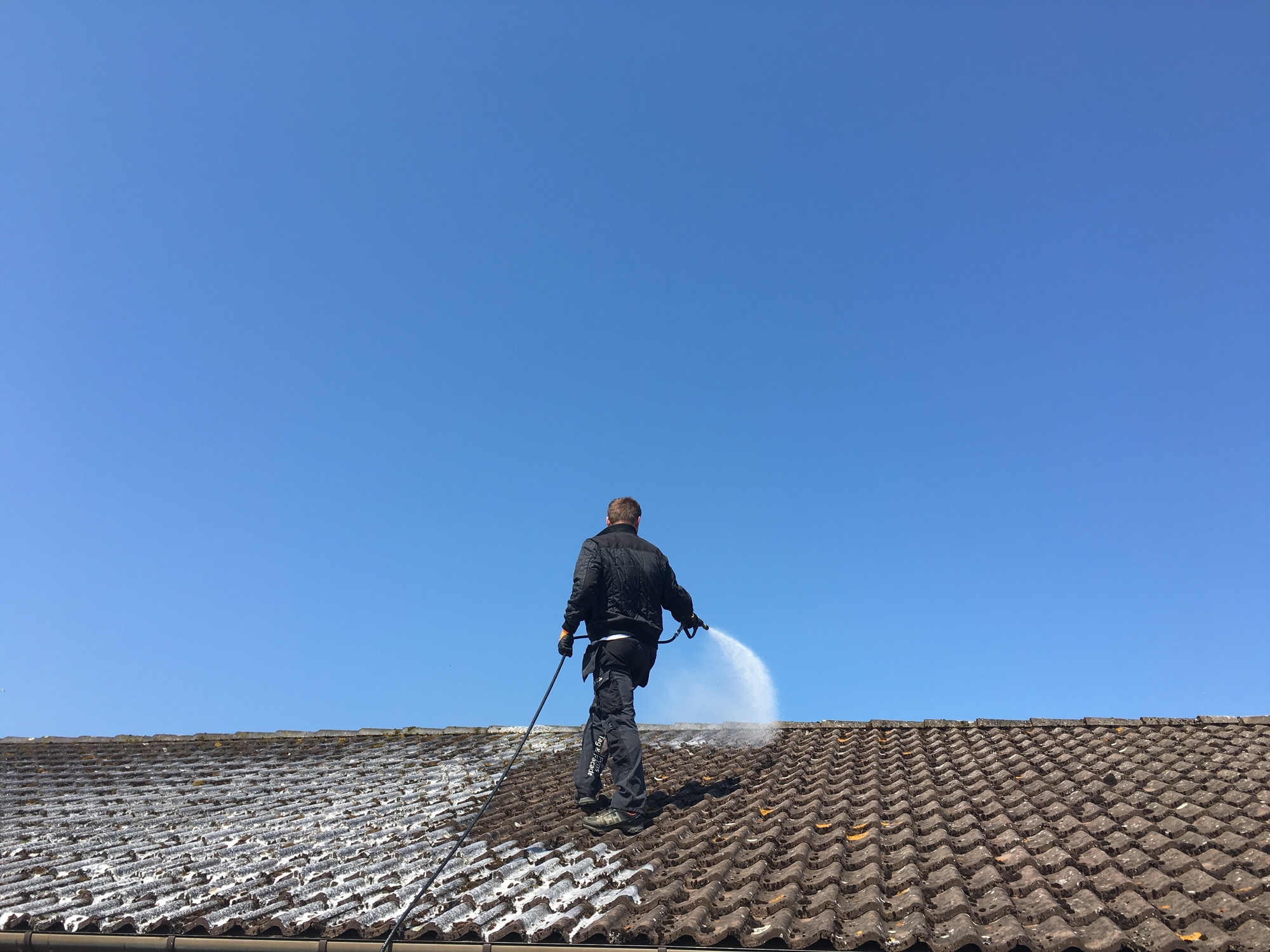 Worker Applying A Roof Coating